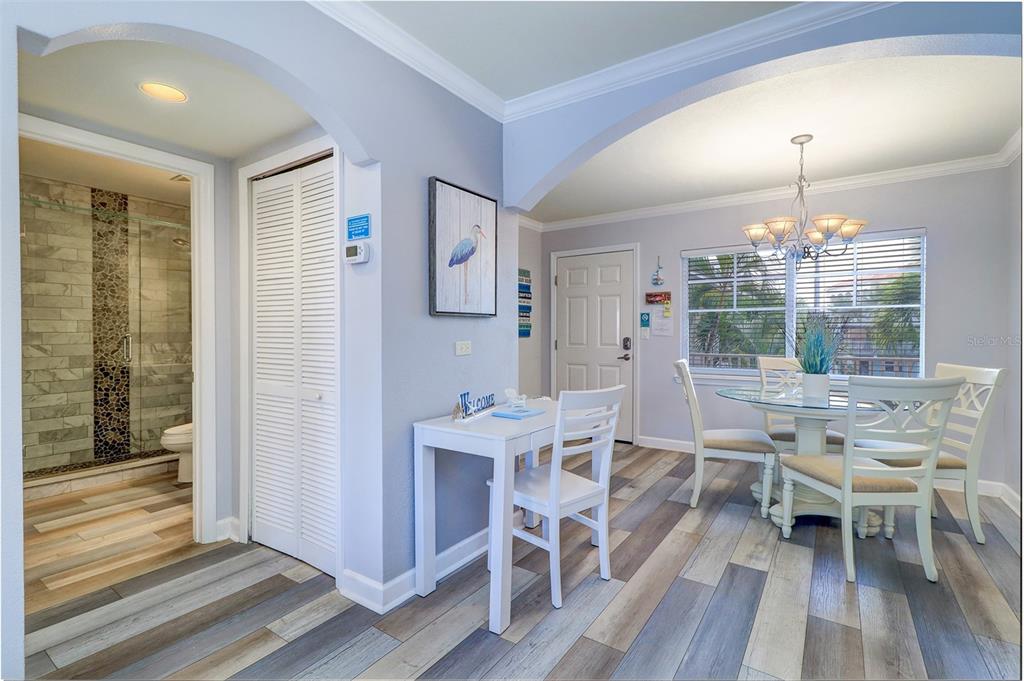 19417 Gulf Boulevard, Unit A202 Indian Shores, FL 33785 - Photo 14 of 35 a view of a dining room with furniture and wooden floor