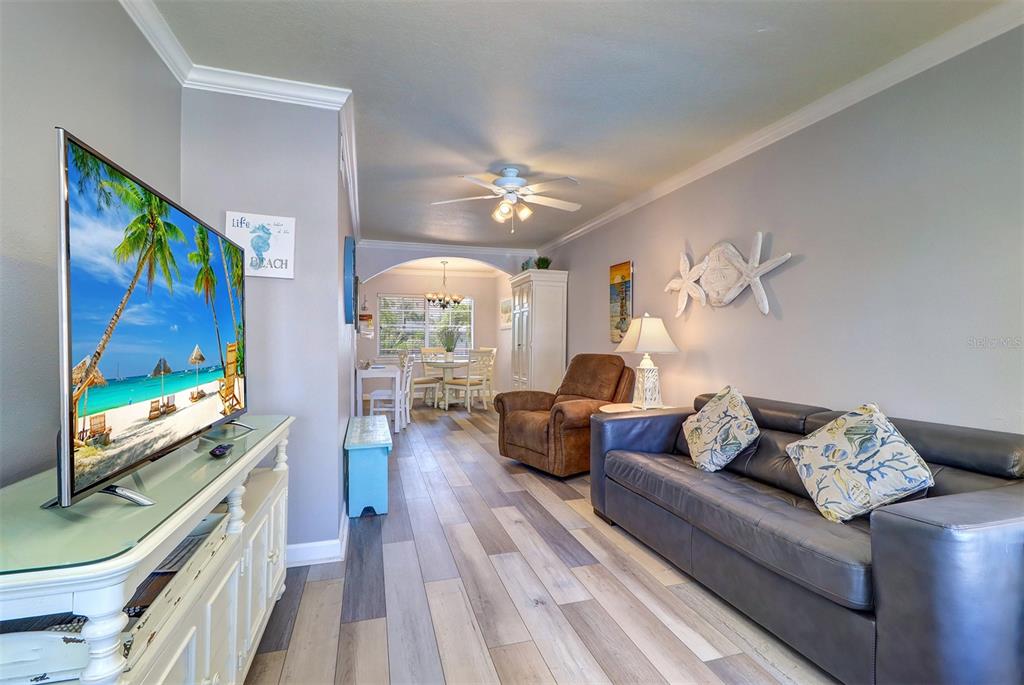 19417 Gulf Boulevard, Unit A202 Indian Shores, FL 33785 - Photo 18 of 35 a living room with furniture and a flat screen tv