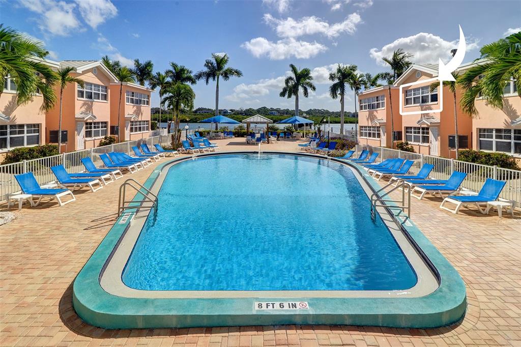 19417 Gulf Boulevard, Unit A202 Indian Shores, FL 33785 - Photo 2 of 35 a view of a swimming pool