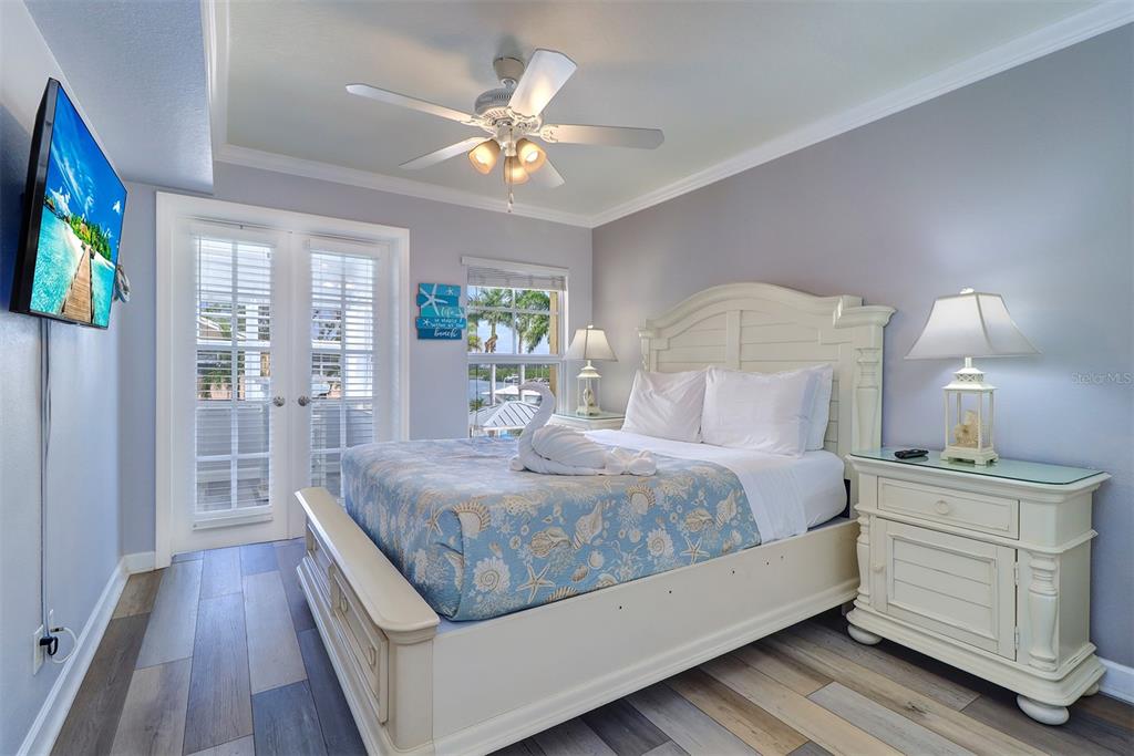 19417 Gulf Boulevard, Unit A202 Indian Shores, FL 33785 - Photo 21 of 35 a bed room with a bed window and a mirror