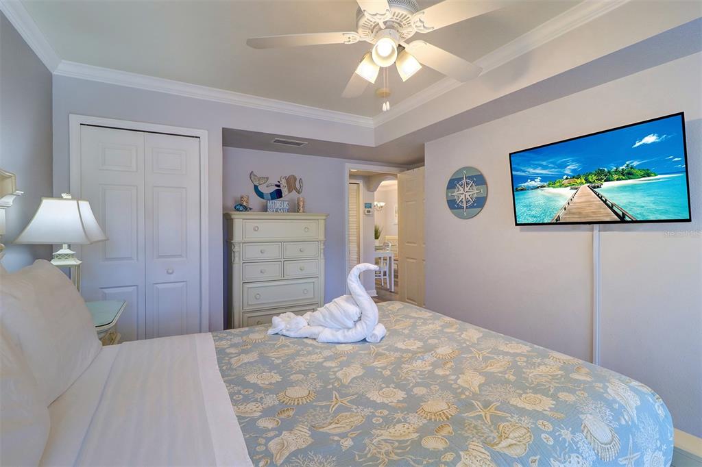19417 Gulf Boulevard, Unit A202 Indian Shores, FL 33785 - Photo 24 of 35 a bedroom with a bed and a painting on the wall