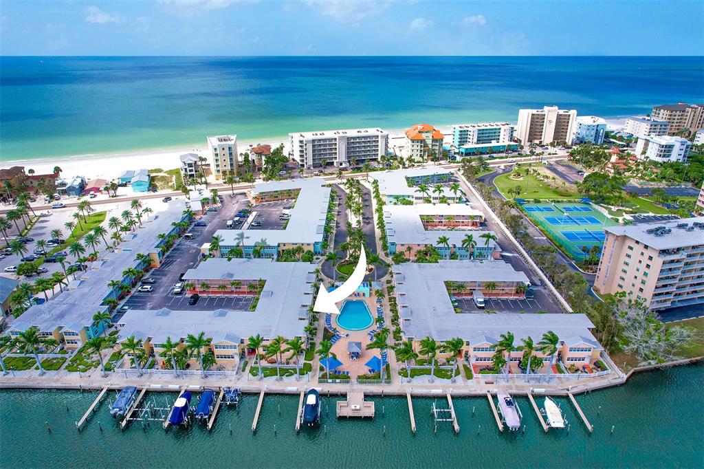 19417 Gulf Boulevard, Unit A202 Indian Shores, FL 33785 - Photo 31 of 35 a view of swimming pool with outdoor seating and plants