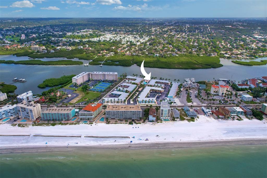 19417 Gulf Boulevard, Unit A202 Indian Shores, FL 33785 - Photo 33 of 35 an aerial view of a city with lots of residential buildings ocean and mountain view in back
