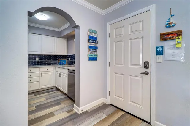 a kitchen with white cabinets and white appliances