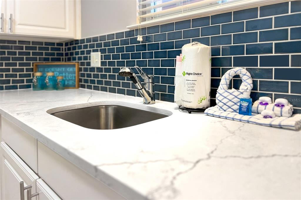 19417 Gulf Boulevard, Unit A202 Indian Shores, FL 33785 - Photo 8 of 35 a view of a sink and dishwasher