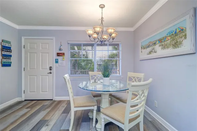 a view of a dining room with furniture wooden floor and chandelier