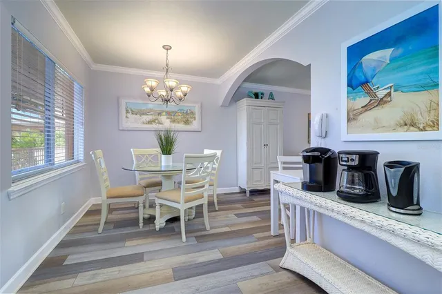 a dining room with furniture a chandelier and window