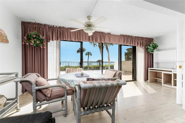 a view of a dining room with furniture water view and a chandelier