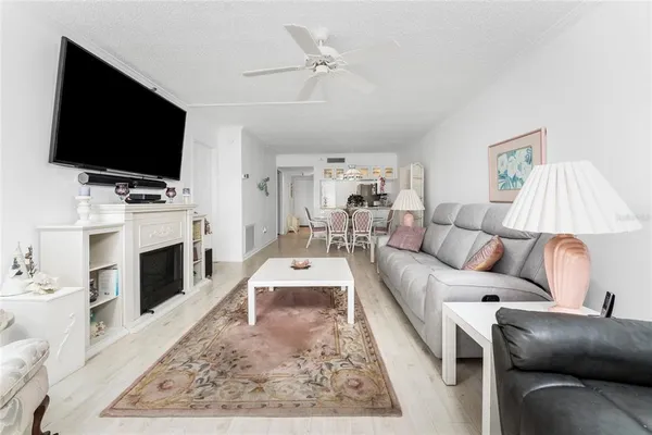 a living room with fireplace furniture and a flat screen tv