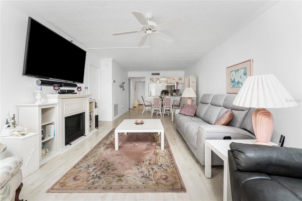 1551 Beach Road, Unit 204 Englewood, FL 34223 - Photo 12 of 55 a living room with fireplace furniture and a flat screen tv