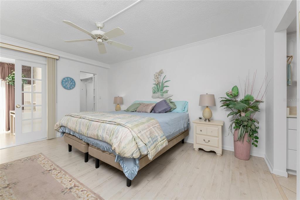1551 Beach Road, Unit 204 Englewood, FL 34223 - Photo 14 of 55 a bedroom with a bed and a potted plant
