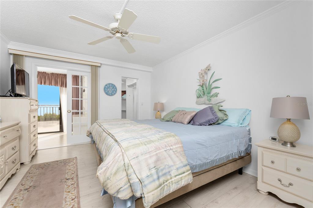 1551 Beach Road, Unit 204 Englewood, FL 34223 - Photo 15 of 55 a bedroom with a bed and a chandelier