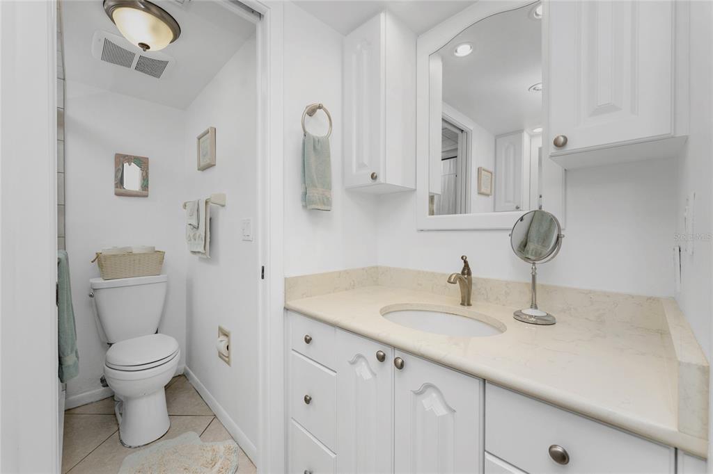 1551 Beach Road, Unit 204 Englewood, FL 34223 - Photo 18 of 55 a bathroom with a toilet sink and mirror