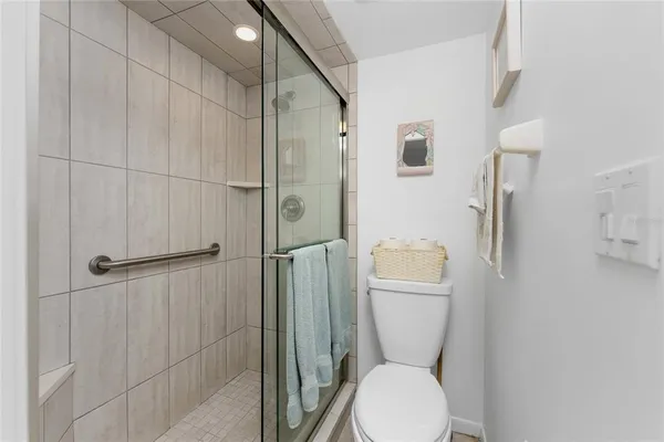 a bathroom with a toilet and a shower