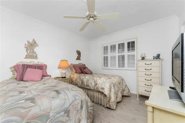 a bedroom with two beds and a dresser