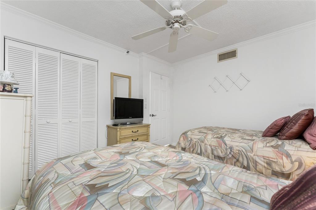1551 Beach Road, Unit 204 Englewood, FL 34223 - Photo 22 of 55 a bedroom with a bed and a flat screen tv