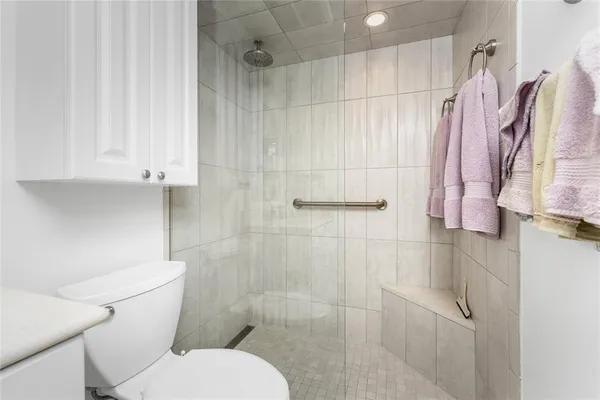 a white toilet sitting next to a bathroom sink