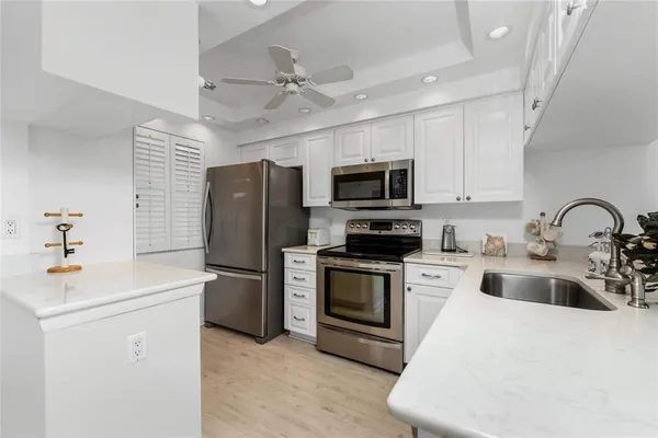 a kitchen with a sink stainless steel appliances and cabinets