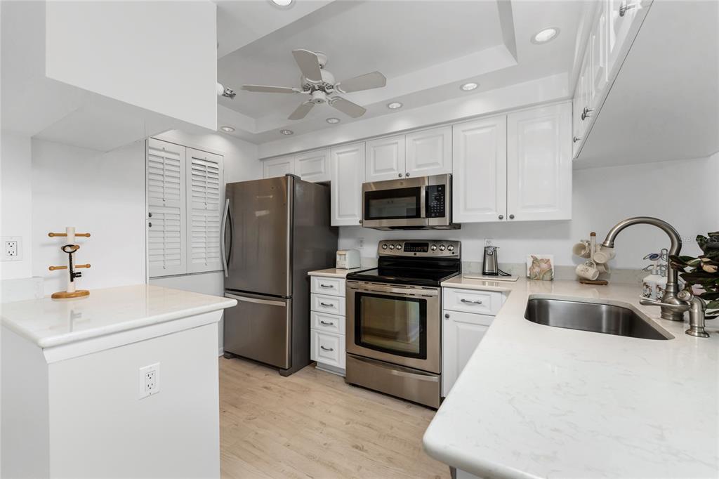 1551 Beach Road, Unit 204 Englewood, FL 34223 - Photo 3 of 55 a kitchen with a sink stainless steel appliances and cabinets
