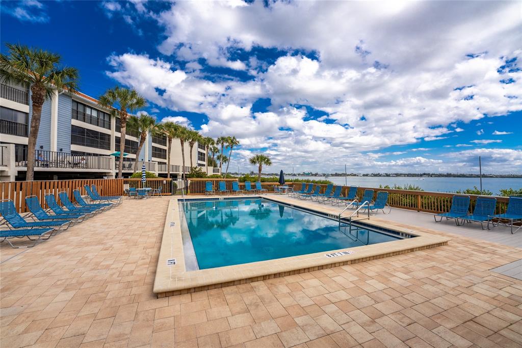 1551 Beach Road, Unit 204 Englewood, FL 34223 - Photo 31 of 55 a view of a swimming pool with an outdoor seating