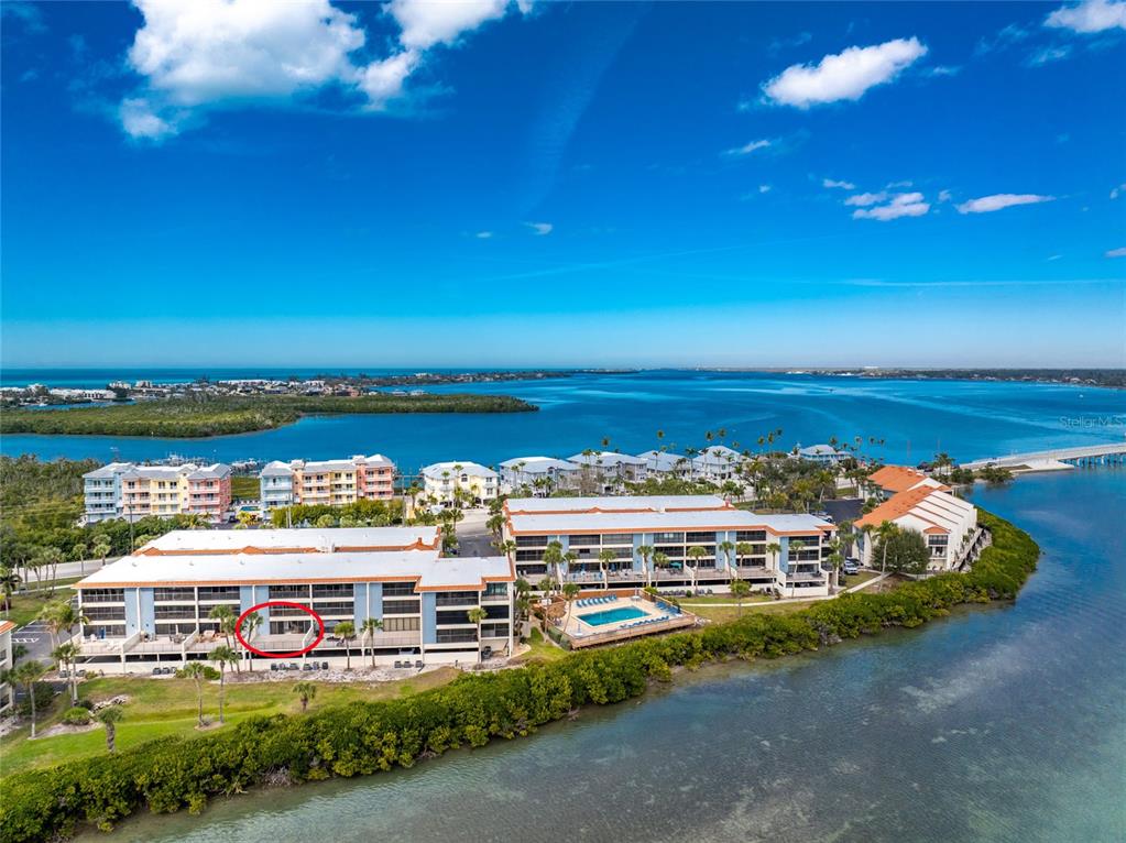1551 Beach Road, Unit 204 Englewood, FL 34223 - Photo 40 of 55 a view of a lake with a building in the background