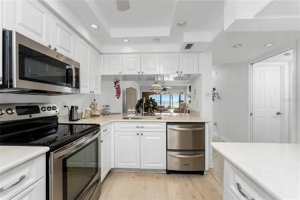 a kitchen with a sink stove and microwave