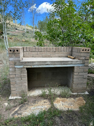1085 West Elk Road Helper, UT 84526 - Photo 30 of 40 Brick outdoor structure with a concrete countertop and built-in storage compartment
