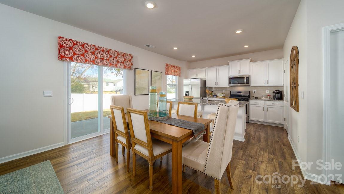 111 Wheatfield Road Fletcher, NC 28732 - Photo 12 of 36 a kitchen with microwave a refrigerator and chairs