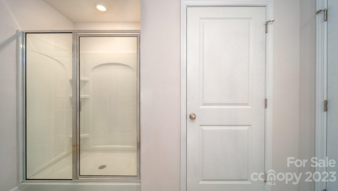 111 Wheatfield Road Fletcher, NC 28732 - Photo 24 of 36 a bathroom with a glass shower door and a mirror