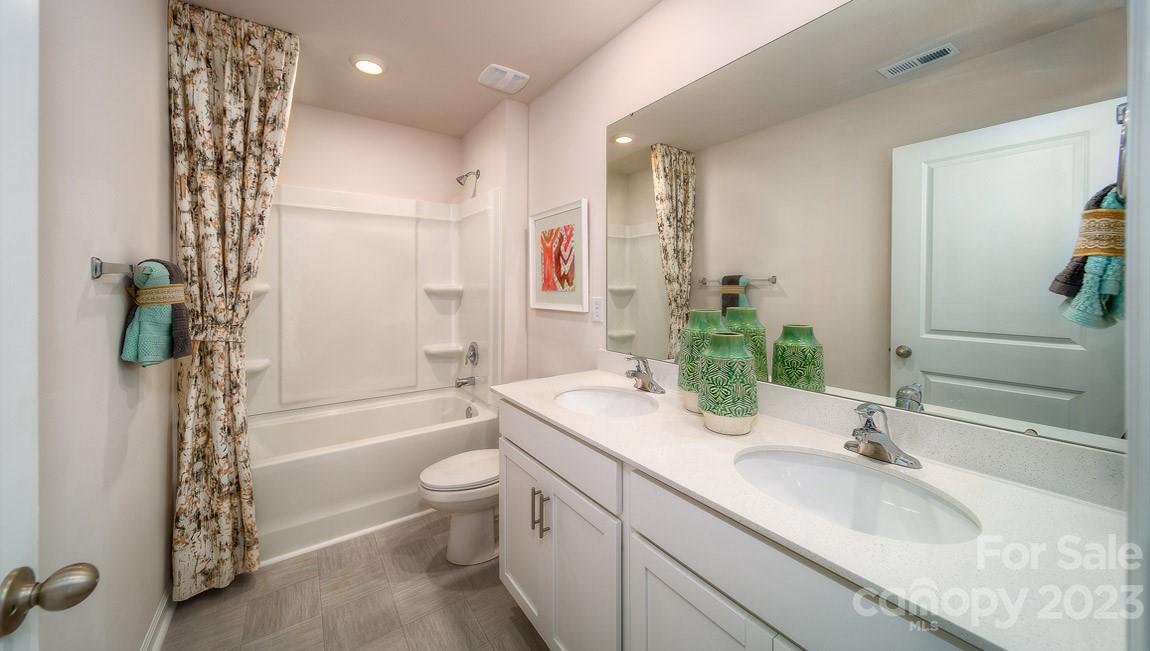 111 Wheatfield Road Fletcher, NC 28732 - Photo 31 of 36 a bathroom with a granite countertop sink a toilet and shower