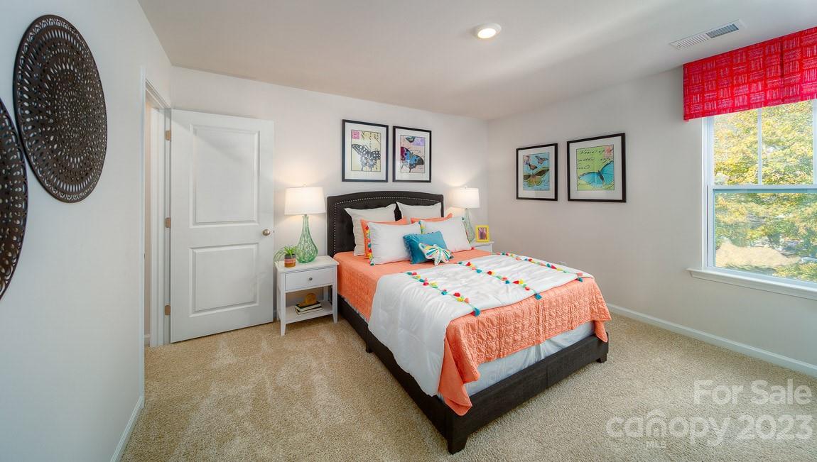 111 Wheatfield Road Fletcher, NC 28732 - Photo 32 of 36 a bedroom with a bed a wall painting and a window