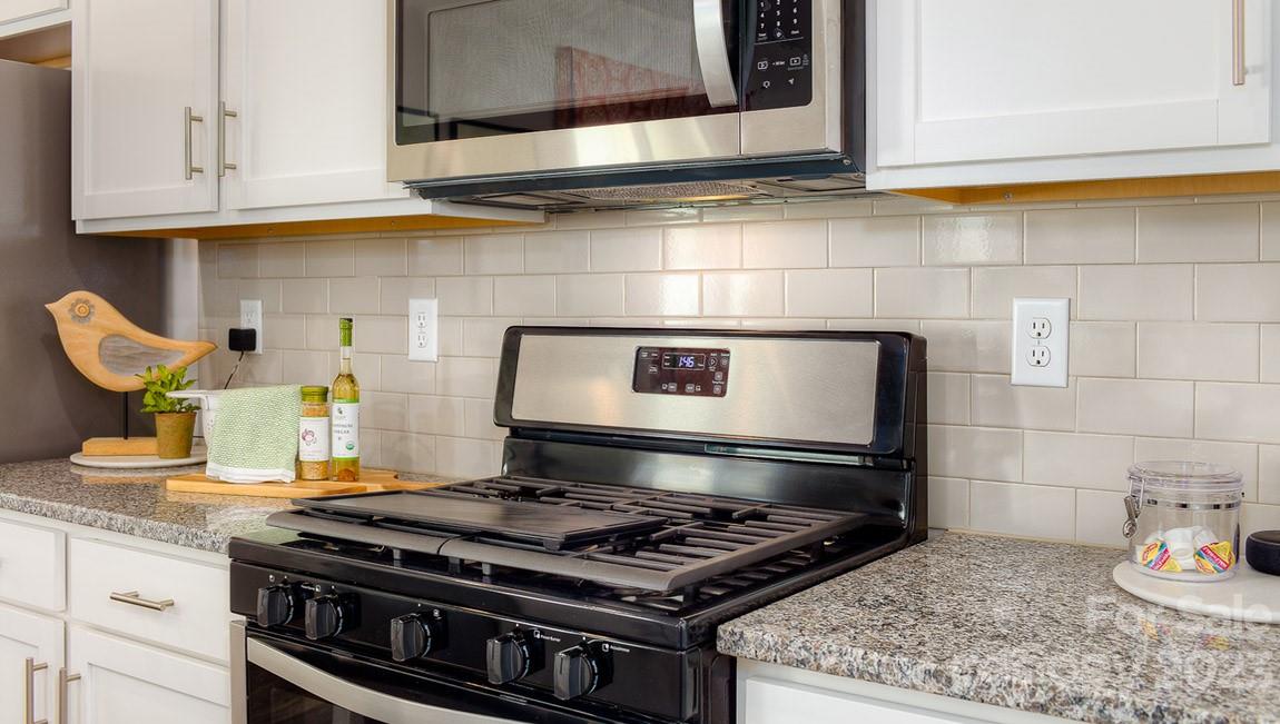 111 Wheatfield Road Fletcher, NC 28732 - Photo 9 of 36 a stove top oven sitting inside of a kitchen