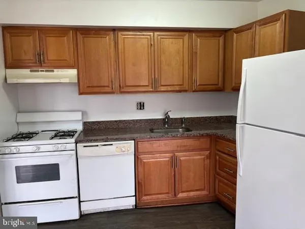 a kitchen with a white cabinets and white appliances