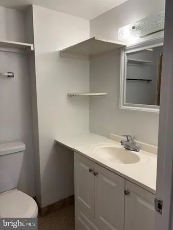 a bathroom with a sink toilet and vanity