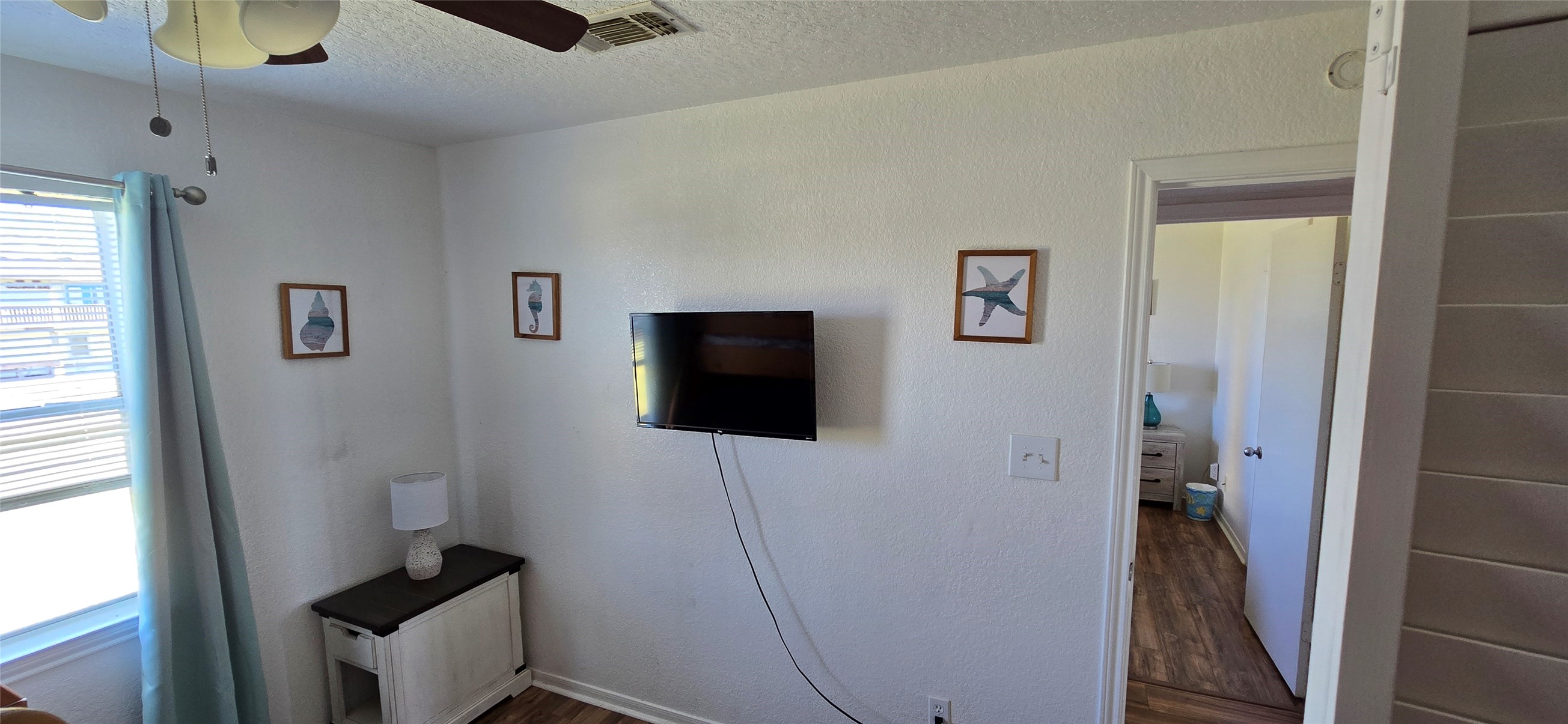 16506 Blackbeard Road, Unit E Jamaica Beach, TX 77554 - Photo 7 of 10 a living room with furniture and a flat screen tv