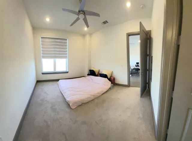 a bedroom with a bed and a window