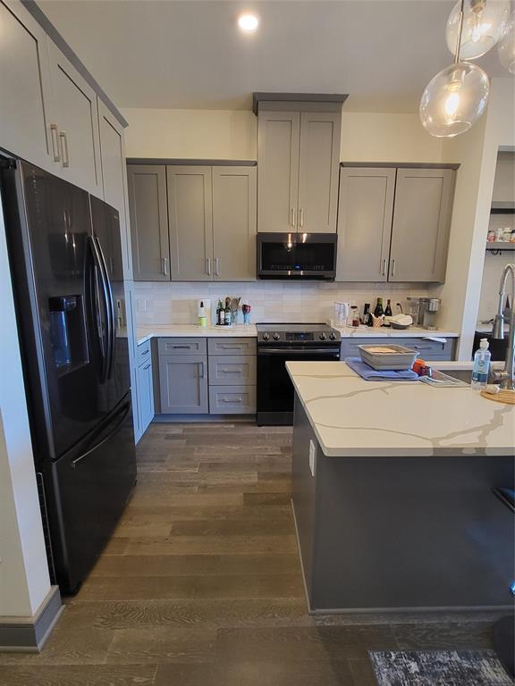 2700 Old Denton Road, Unit 3314 Carrollton, TX 75007 - Photo 4 of 18 a kitchen with kitchen island granite countertop a sink stove and refrigerator