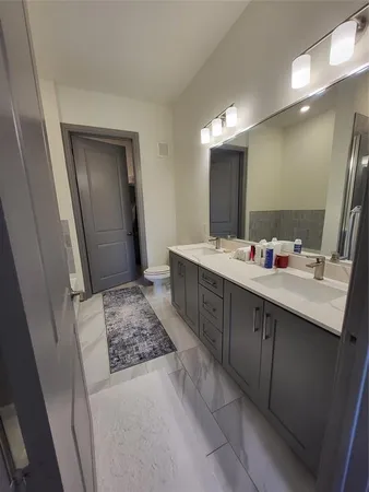 a bathroom with a double vanity sink a mirror and a