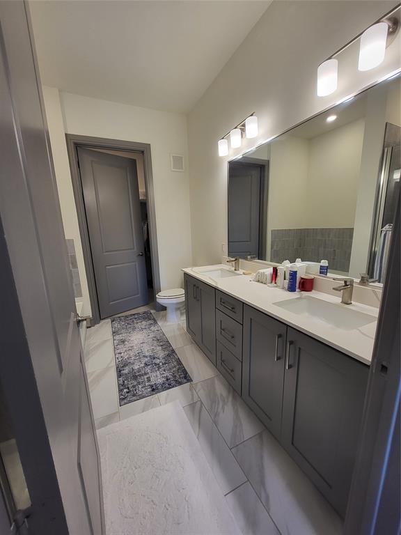 2700 Old Denton Road, Unit 3314 Carrollton, TX 75007 - Photo 6 of 18 a bathroom with a double vanity sink a mirror and a