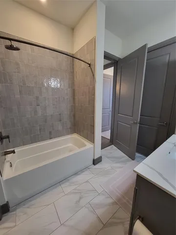 a bathroom with a bathtub and a shower