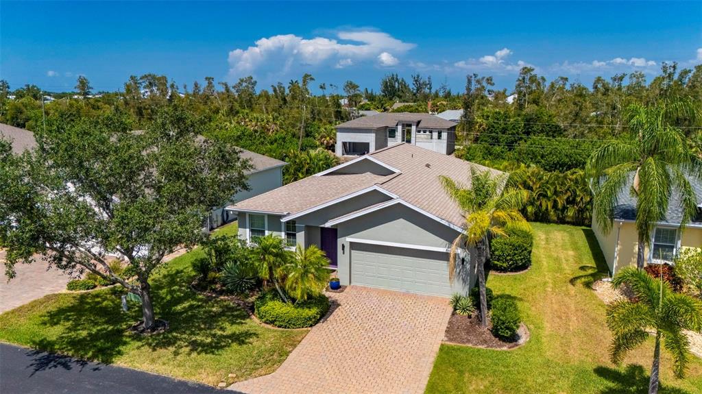 24604 Rio Villa Lakes Circle Punta Gorda, FL 33950 - Photo 2 of 28 a front view of a house with a yard and trees