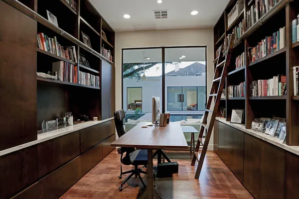 a view of a dining room with furniture and a book shelf