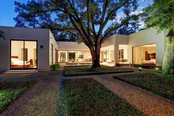 a front view of a house with garden and patio