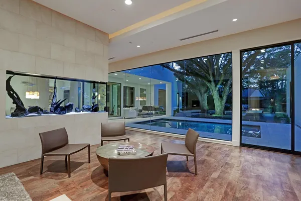 a living room with furniture a large window and a table