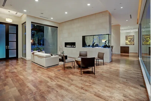 a living room with furniture and a wooden floor