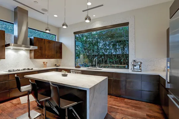 a kitchen with a stove a sink and a refrigerator