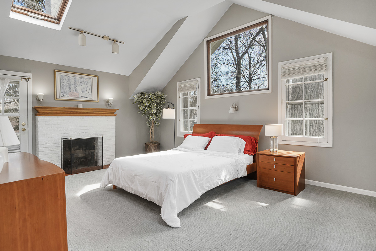 515 Maple Avenue Wilmette, IL 60091 - Photo 11 of 26 a bedroom with a bed and a fireplace