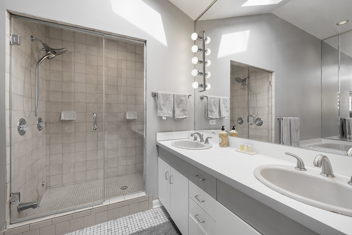 515 Maple Avenue Wilmette, IL 60091 - Photo 12 of 26 a bathroom with a double vanity sink mirror and shower