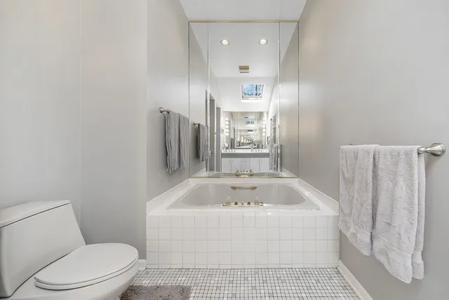 a bathroom with a sink a toilet and bathtub