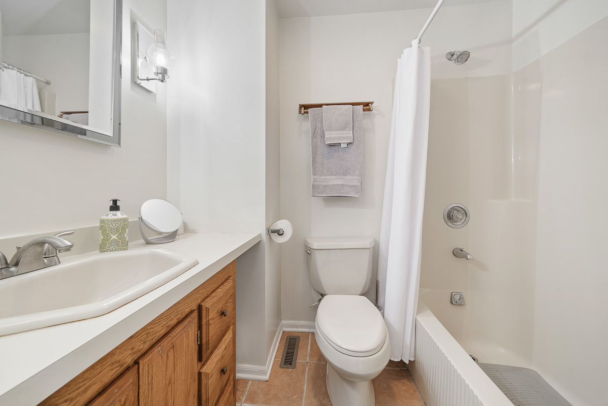 515 Maple Avenue Wilmette, IL 60091 - Photo 16 of 26 a bathroom with a granite countertop sink a toilet and shower